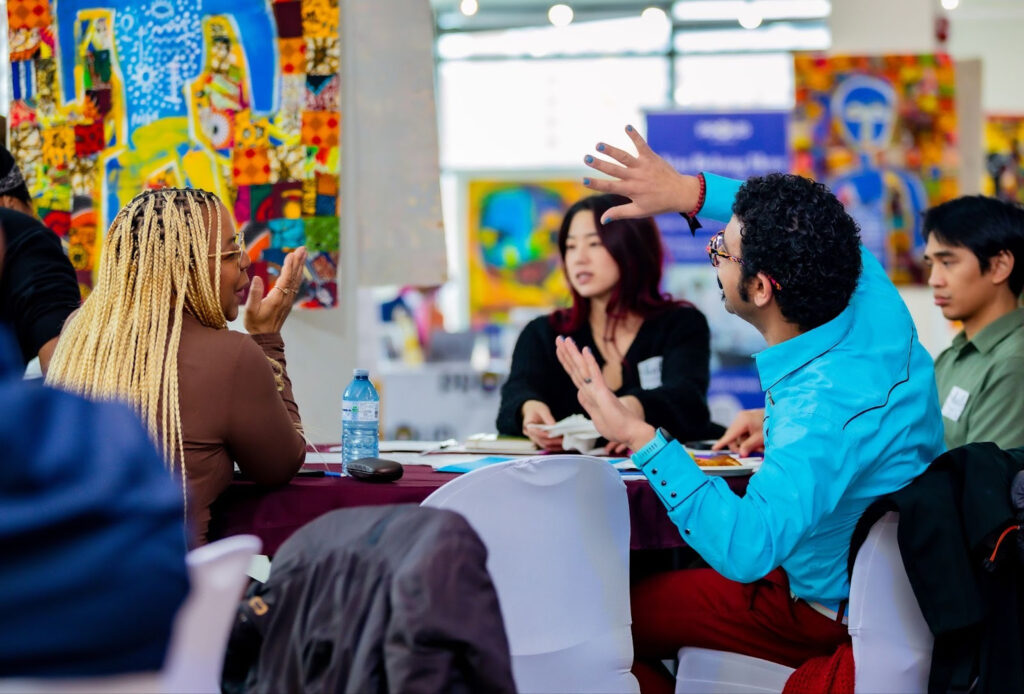 Participants engage in dialogue on reclaiming belonging in LGBTQI+ movements during the “Pride Beyond Borders” plenary session.