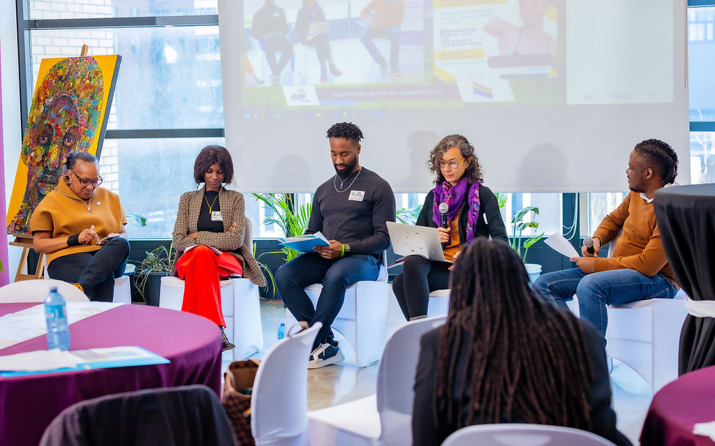 Panelists and participants engage in dialogue on enhancing participation of queer refugees in community leadership during the “Breaking Barriers” roundtable.