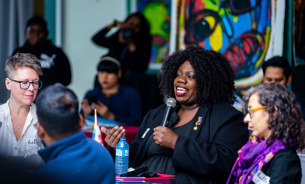 Participants engage in dialogue on reclaiming belonging in LGBTQI+ movements during the “Pride Beyond Borders” plenary session.